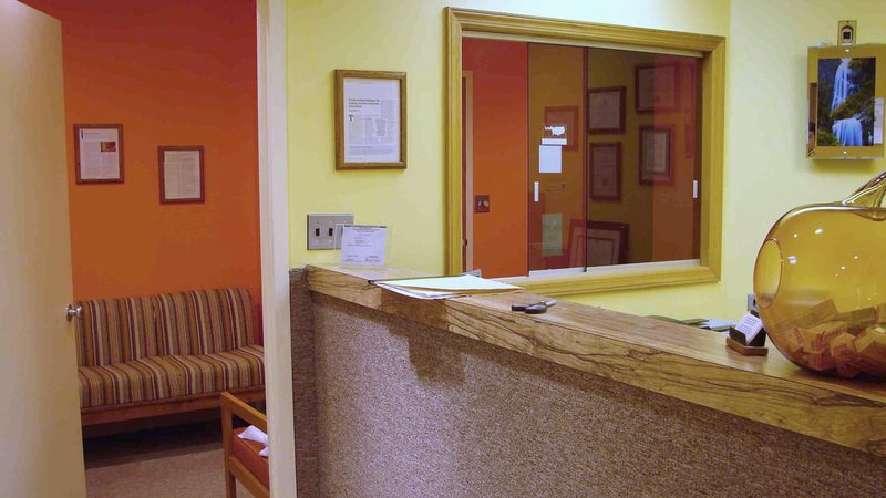 The front desk at Sunbeam Dental, with the waiting room beyond