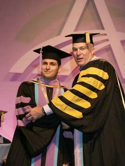 Dr. John Mamoun (left) receiving his Fellowship from Academy of General Dentistry president Dr. Bruce A. Burton, August 2006